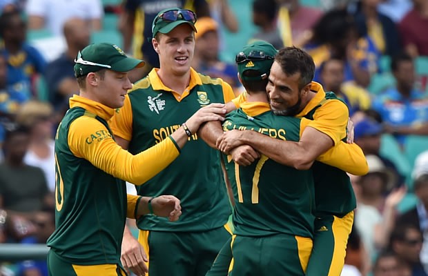 South Africa's Imran Tahir (R) hugs teammate AB de Villiers (2nd R)